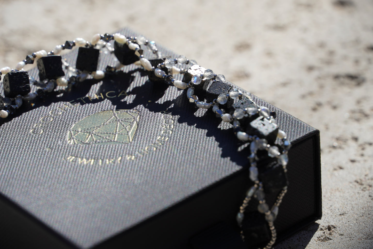 Lava rock bead texture detail on handmade gemstone bracelet