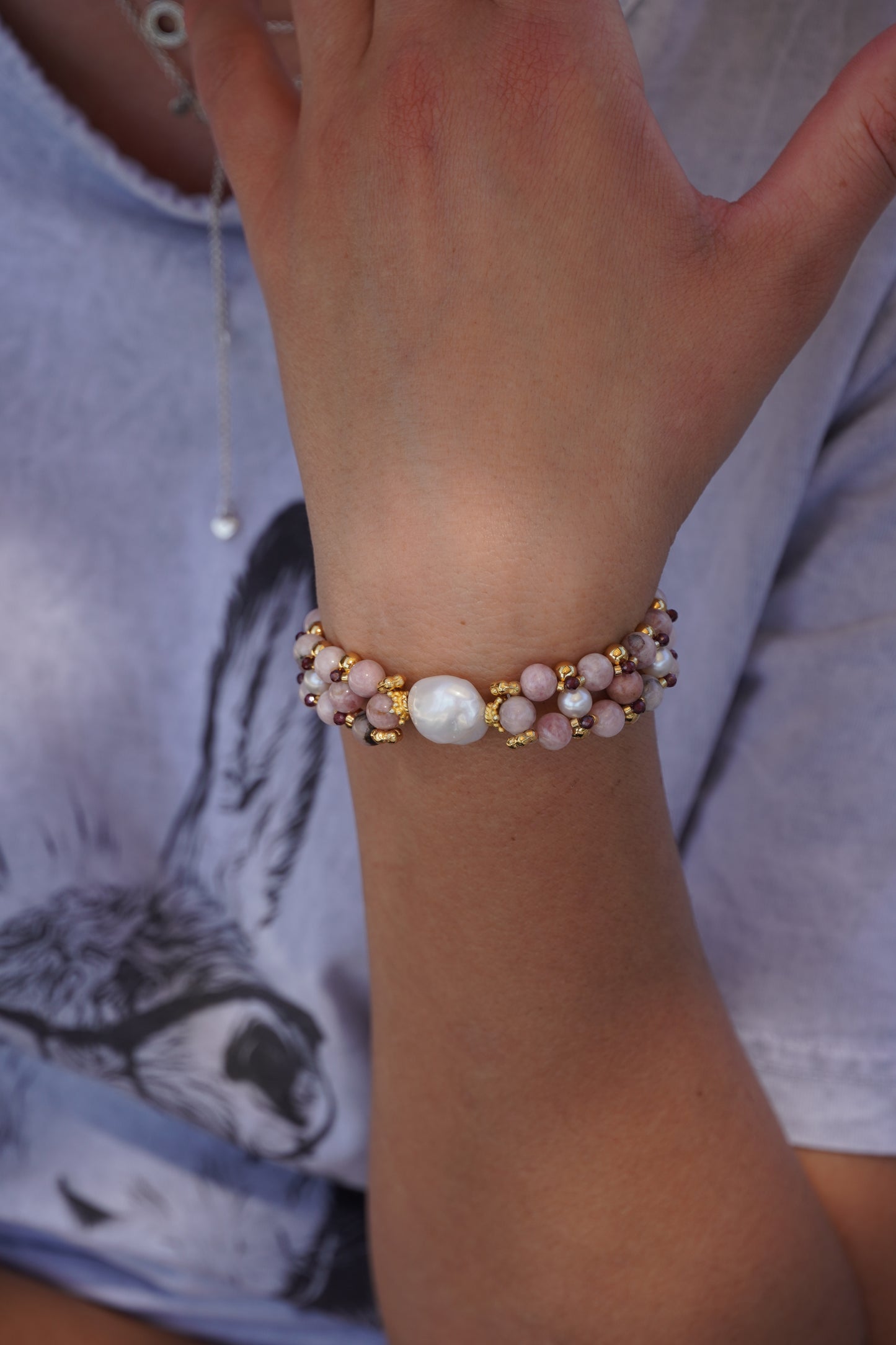 hand wearing a multi gemstone bracelet