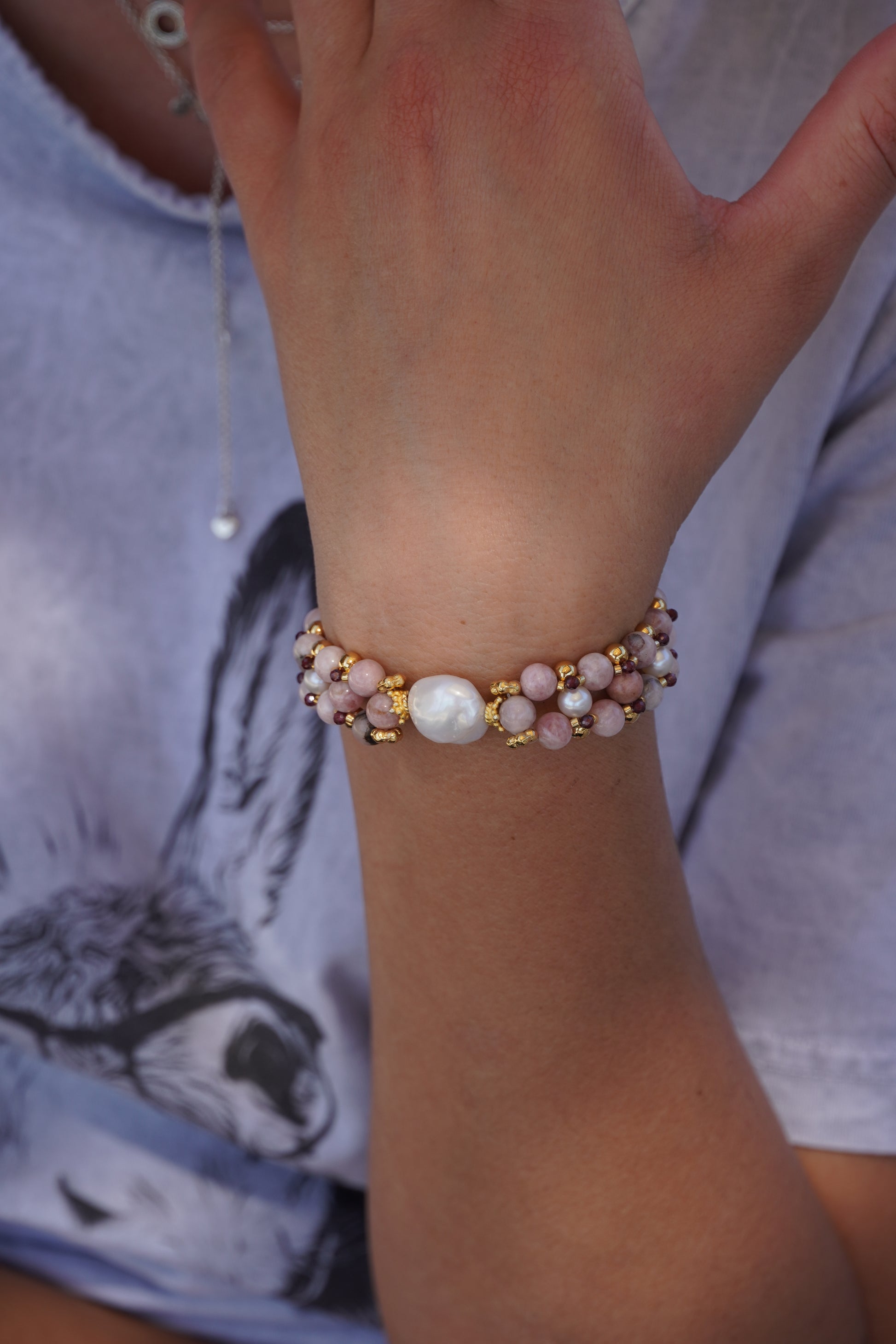 hand wearing a multi gemstone bracelet
