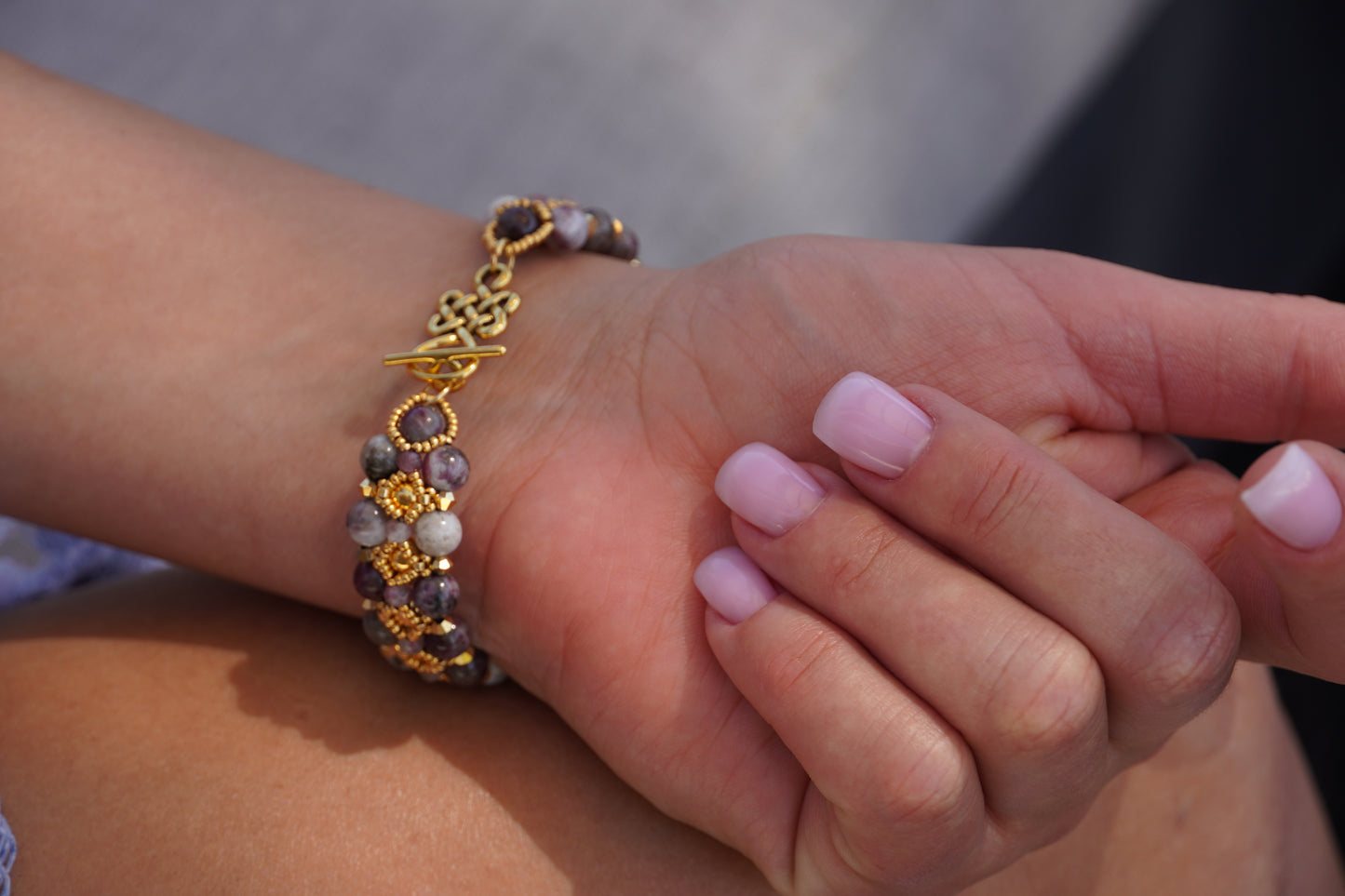 hand wearing a tourmaline bracelet
