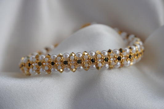 closeup of a beaded bracelet with gold accents