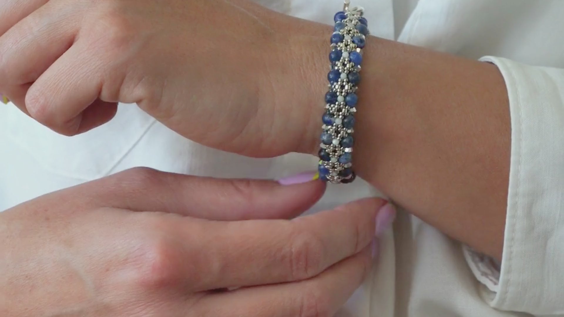 Load video: Woman showing off gemstone bracelets on her hands